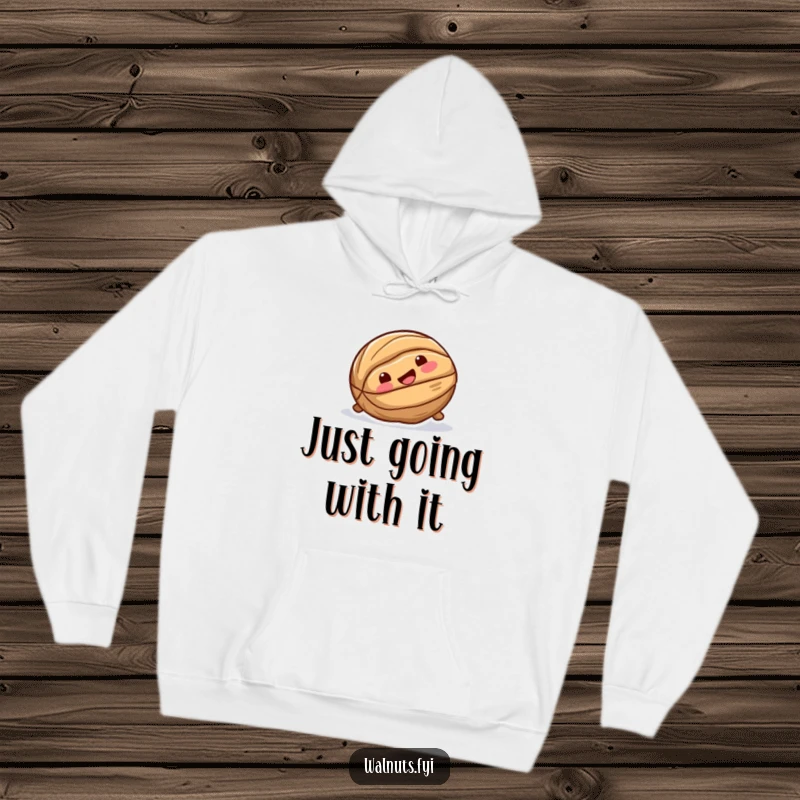 Funny hoodie featuring a playful walnut with a joyful expression, captured mid-slide down a smooth, glossy surface.