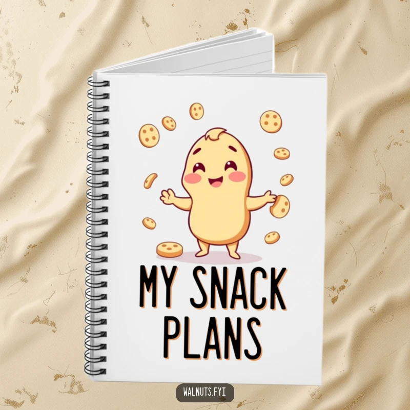 Funny notebook with a cheerful cashew juggling cookies, ideal for writing recipes or snack-related ideas.